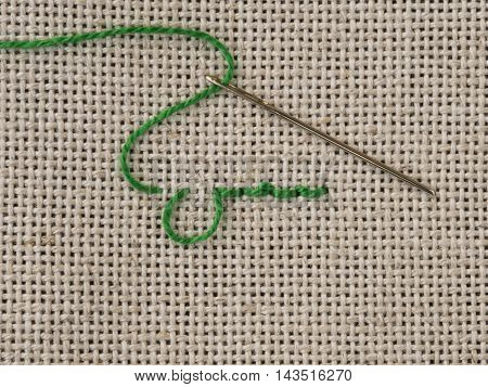 Some embroidery stitches on the canvas with a needle