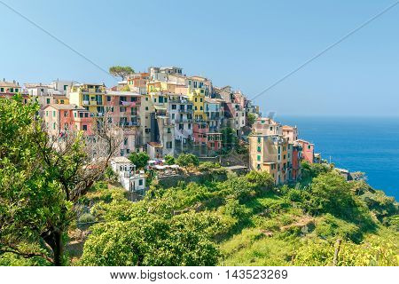View of the colorful houses facades of the traditional medieval Italian village Corniglia. Cinque Terre. Italy.