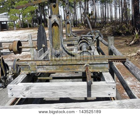 A restored turpentine still at St. Andrews State Park Panama City Florida includes the sawmill used to cut wood for the distilling process.