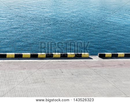 Textured Background Of Sea Water And A Pier In The City Seaport