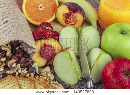 Fruits and nut mix - Fruits and nuts background with a mix of apples, oranges, bananas, peach, strawberries and different types of nuts, like walnuts, almonds, hazelnuts, raisins and cashew.