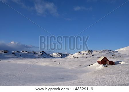 Wooden house on the snowcovered Norwegian mountain plateau Hardangervidda