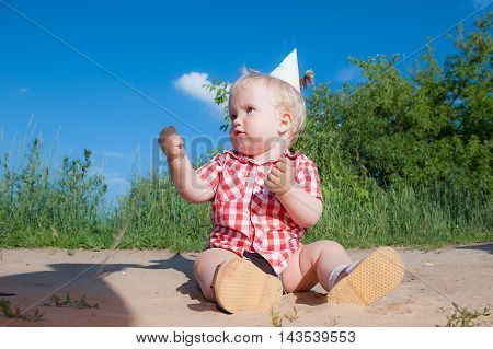Litle boy on playground in summer park