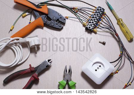 Set of electrical tool on wooden background. Accessories for engineering work, energy concept