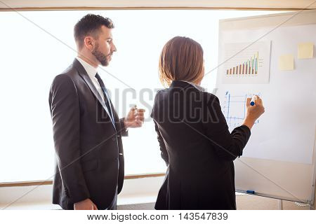 Business Partners Doing Some Work On A Flipchart