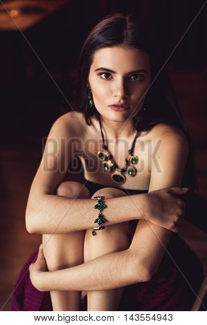 closeup shot of young brunette model posing in burlesque fitting room