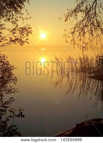 The silence summer sun sunrise .Voskhod on the misty river.