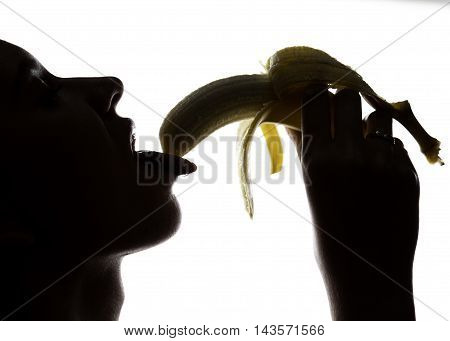 Young amazed woman in lacy lingerie holding a banana, she is going to eat a banana. she sucks a banana.