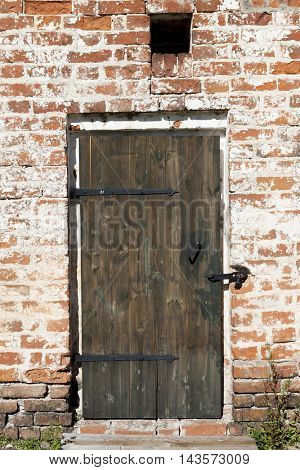 Old door in the stone walls of the village houses. Excellent background