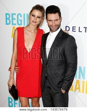 NEW YORK-JUNE 25: Behati Prinsloo (L) and Adam Levine attend the New York premiere of 