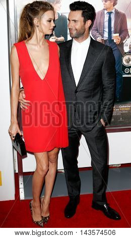 NEW YORK-JUNE 25: Behati Prinsloo (L) and Adam Levine attend the New York premiere of 