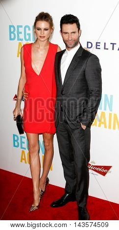 NEW YORK-JUNE 25: Behati Prinsloo (L) and Adam Levine attend the New York premiere of 