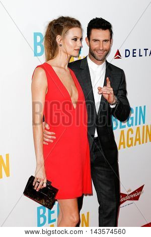 NEW YORK-JUNE 25: Behati Prinsloo (L) and Adam Levine attend the New York premiere of 