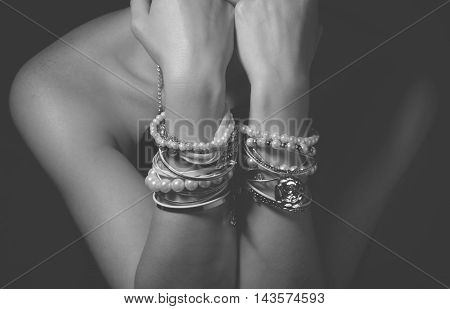 Collection of bracelets on the hands of a woman