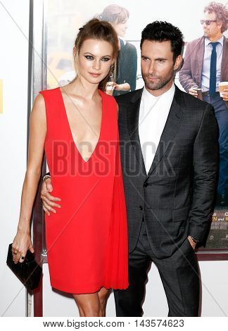 NEW YORK-JUNE 25: Behati Prinsloo (L) and Adam Levine attend the New York premiere of 