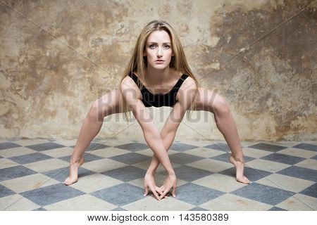 Young woman poses before a brown background