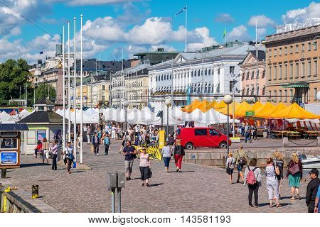 HELSINKI FINLAND - JULY 19 2016: Tourists visiting and shopping at Market Square near Helsinki Northern Harbour