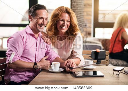 Lovely couple. Smiling couple making selfie photos with the help of smart phone and selfie stick