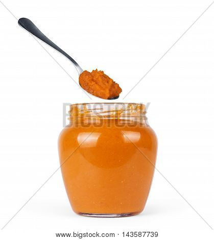 squash puree in a glass jar on a white background