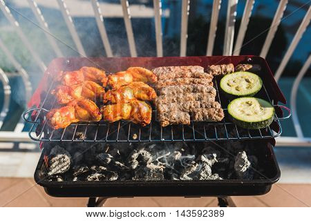 Delicious Meat On Barbecue Grill With Coal On Balcony.