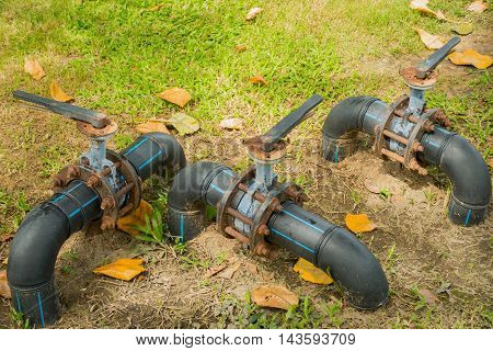 Water control valve on field grass HDPE pipeline.