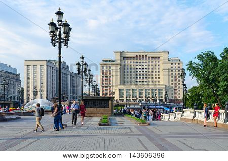 MOSCOW RUSSIA - JULY 23 2016: Unidentified people walk on Manezhnaya Square near Four Seasons Hotel Moscow 5 * (previously - hotel 