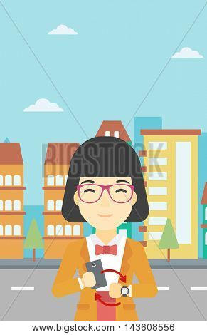 An asian young woman holding a smartphone looking at her smart watch. Concept of synchronization between smartwatch and smartphone. Vector flat design illustration. Vertical layout.