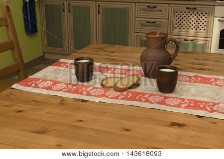 Still life with pottery milk and bread in the kitchen in the countryside