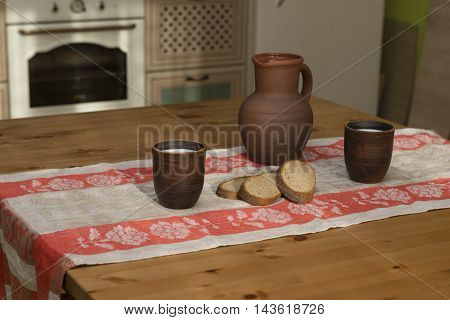 Still life with pottery milk and bread in the kitchen in the countryside
