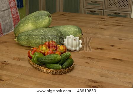zucchini squash tomatoes and cucumbers on the table in the kitchen in the countryside