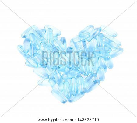 Heart shape made of blue softgel pills isolated over the white background