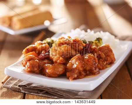 plate of chinese general tsos chicken with rice and broccoli