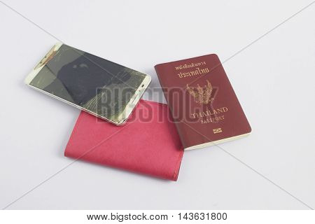 Modern mobile phone with broken screen on white background. thailand passport.