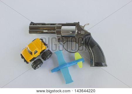 Pistol Revolver Handgun Isolated On White Background. car and a plane.