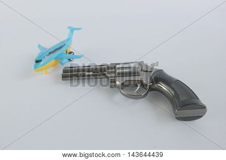 Pistol Revolver Handgun and a plane Isolated On White Background.