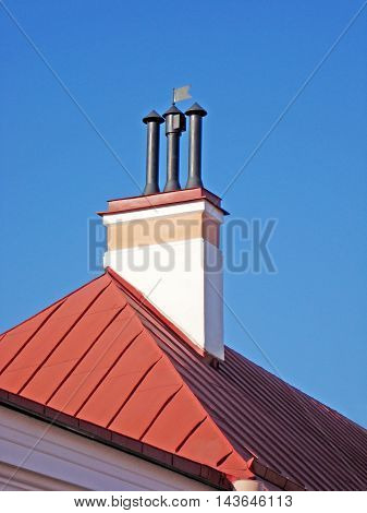 Roof with chimney and pipe. Fragment of house with smokestack.