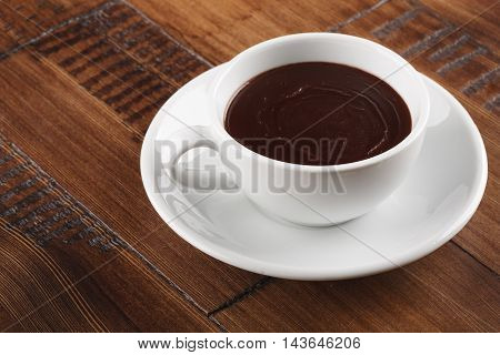 white cup of sweet chocolate on brown wood table