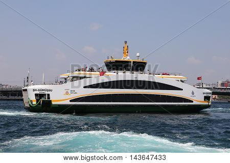 ISTANBUL TURKEY - JULY 28 2016: Sehir Hatlari ferry passing from European side to side Asian of Istanbul. Sehir Hatlari was established in 1844 and now carry 150000 passengers a day.