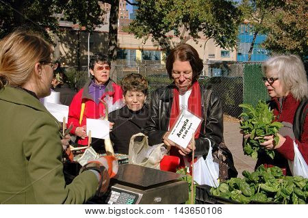 New York City - October 27 2006: Women shopping for fresh produce at the West 97th Street farmer's market