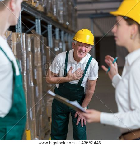 Older warehouseman having a painful infarction at work