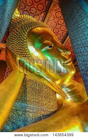 Closed up reclining Buddha Image at Wat Pho Bangkok Thailand. Generally in Thailand any kind of art decorated in Buddhist church temple pavilion temple hall monk's house etc. created with money donated by people to hire artist. They are public domain or t
