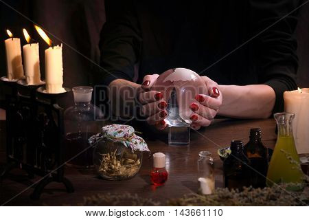 Hands Witch. Transparent Sphere. Magical Objects And Utensils Of The Alchemist. Candles, Herbs. Conc