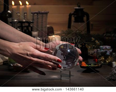 Hands Witch. Transparent Sphere. Magical Objects And Utensils Of The Alchemist. Candles, Herbs. Conc