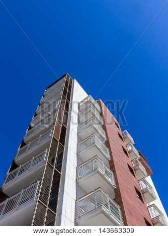 Modern residential building facade with balconies. Bottom view.