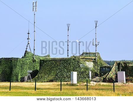 Camouflaged field command communication and observation point with radio communication equipment at the training camp