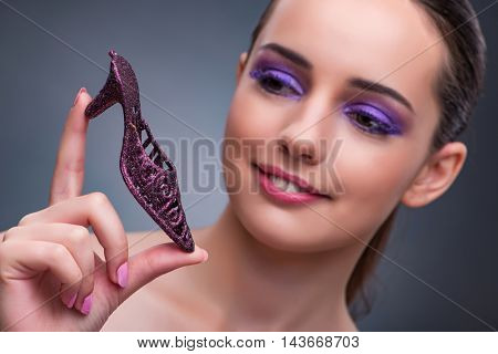 Young woman with purple show in fashion concept