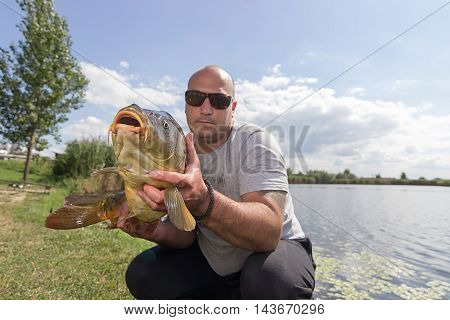 Angler with carp fishing trophy Carp and Fisherman, Carp fishing trophy