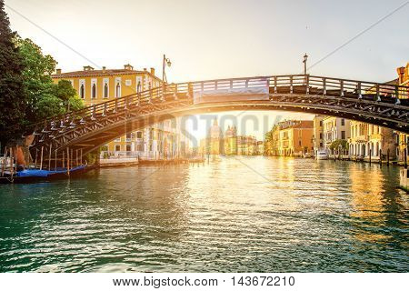 View on Accademic wooden bridge on Gran canal at the sunrise in Venice