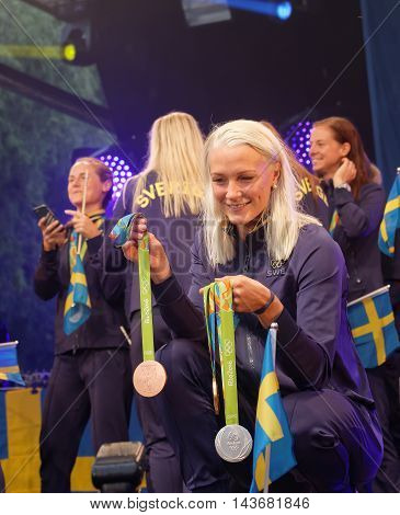 STOCKHOLM SWEDEN - AUG 21 2016: Famous swimmer Sarah Sjostrom showing her medals from the olympic games when the swedish olympics are celebrated in Kungstradgarden Stockholm Sweden August 21 2016