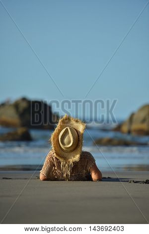 young woman relaxing on the beach in summer day